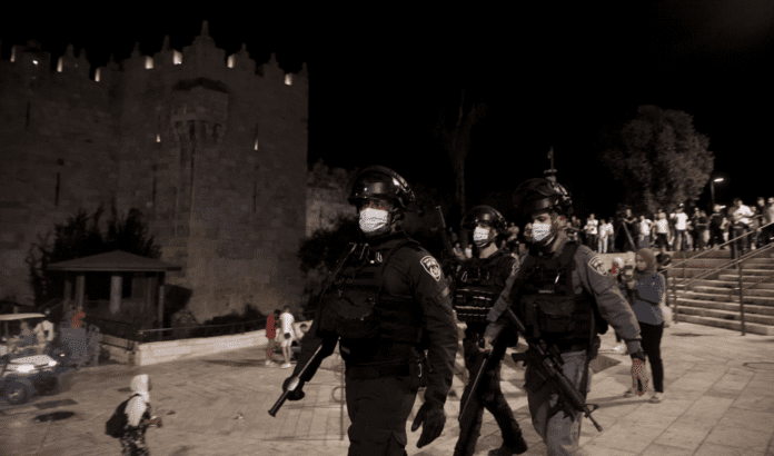Nazi police officer beats Palestinian who complained about police violence